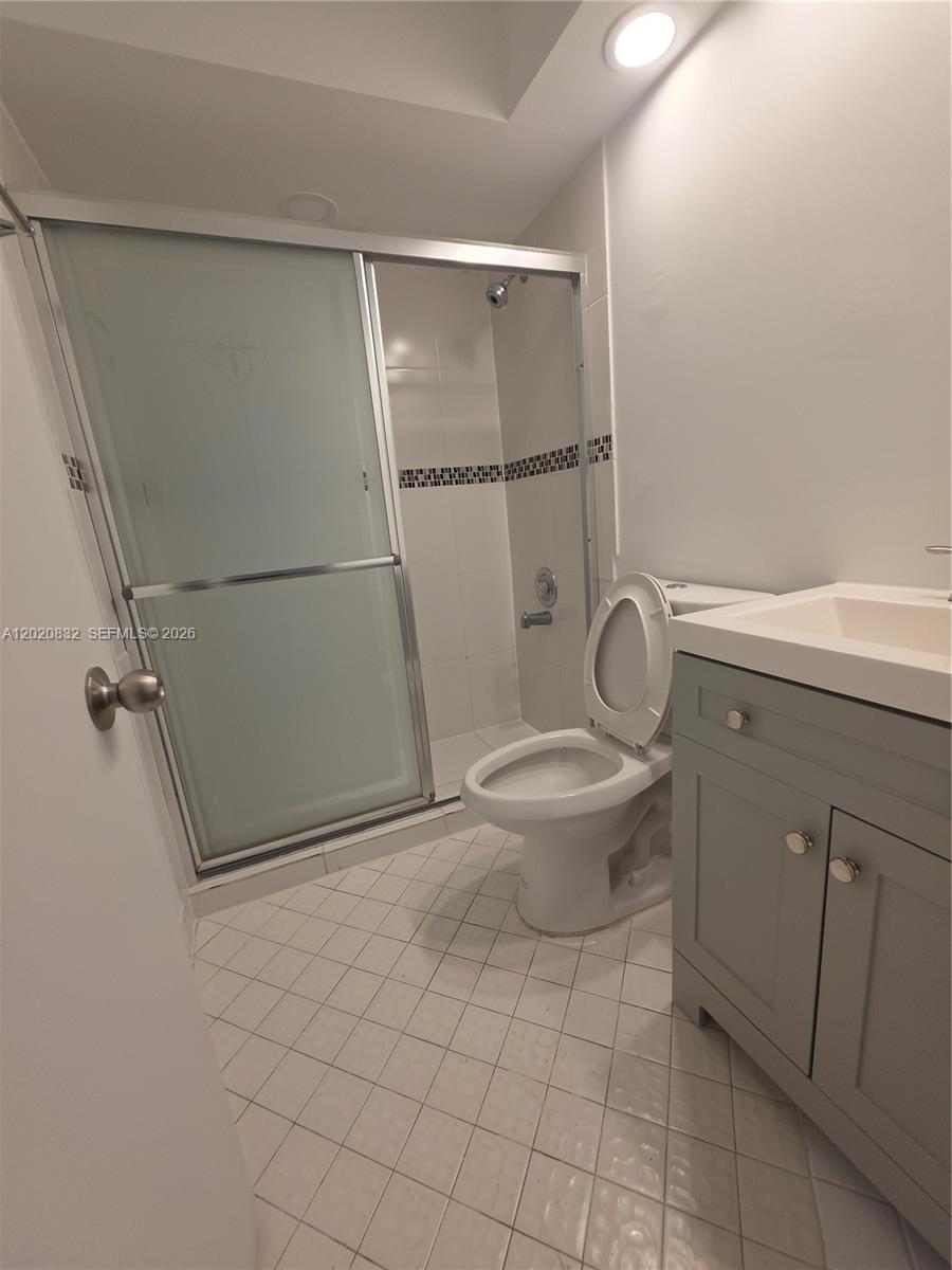 15240 Southwest 45th Terrace, Unit 54F Miami, FL 33185 - Photo 24 of 48 a bathroom with a granite countertop sink toilet and shower