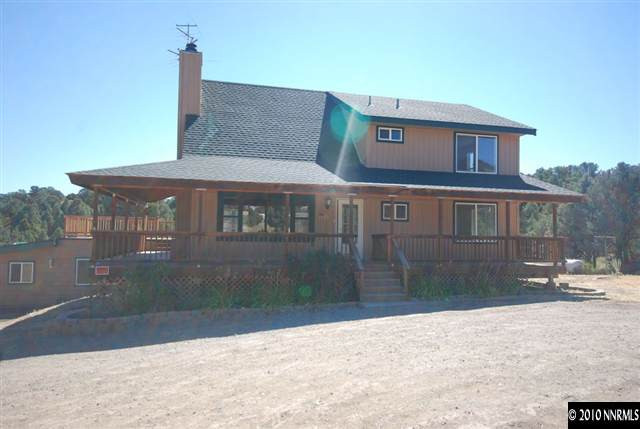 1885 Empire Road Reno, NV 89521 - Photo 1 of 13 a front view of a house with a yard