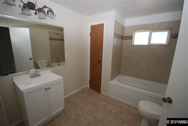 1885 Empire Road Reno, NV 89521 - Photo 9 of 13 a bathroom with a sink a toilet and shower