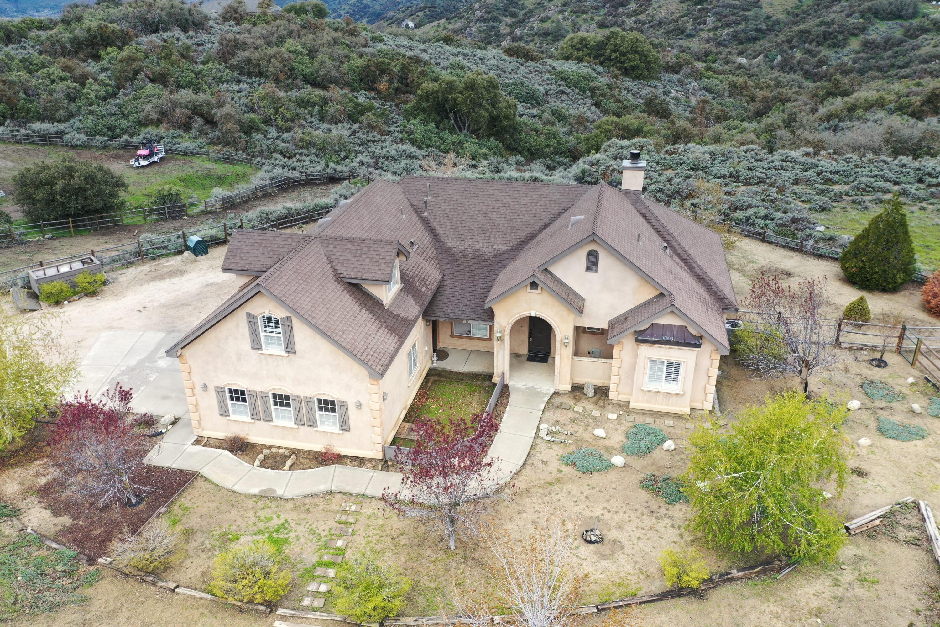 24281 Jacaranda Drive Tehachapi, CA 93561 - Photo 1 of 54 an aerial view of a house with a yard