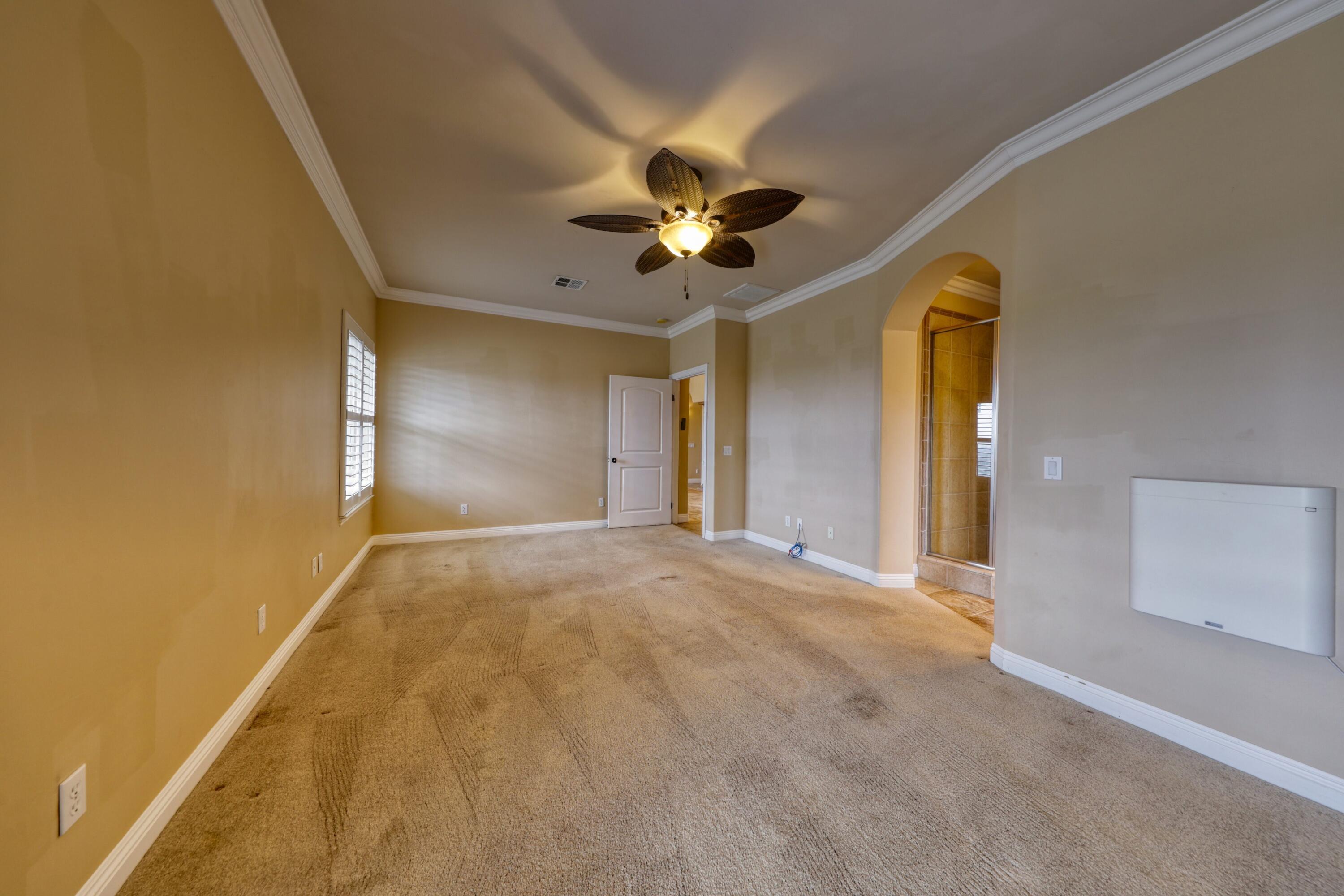 24281 Jacaranda Drive Tehachapi, CA 93561 - Photo 16 of 54 a view of an empty room and a ceiling fan