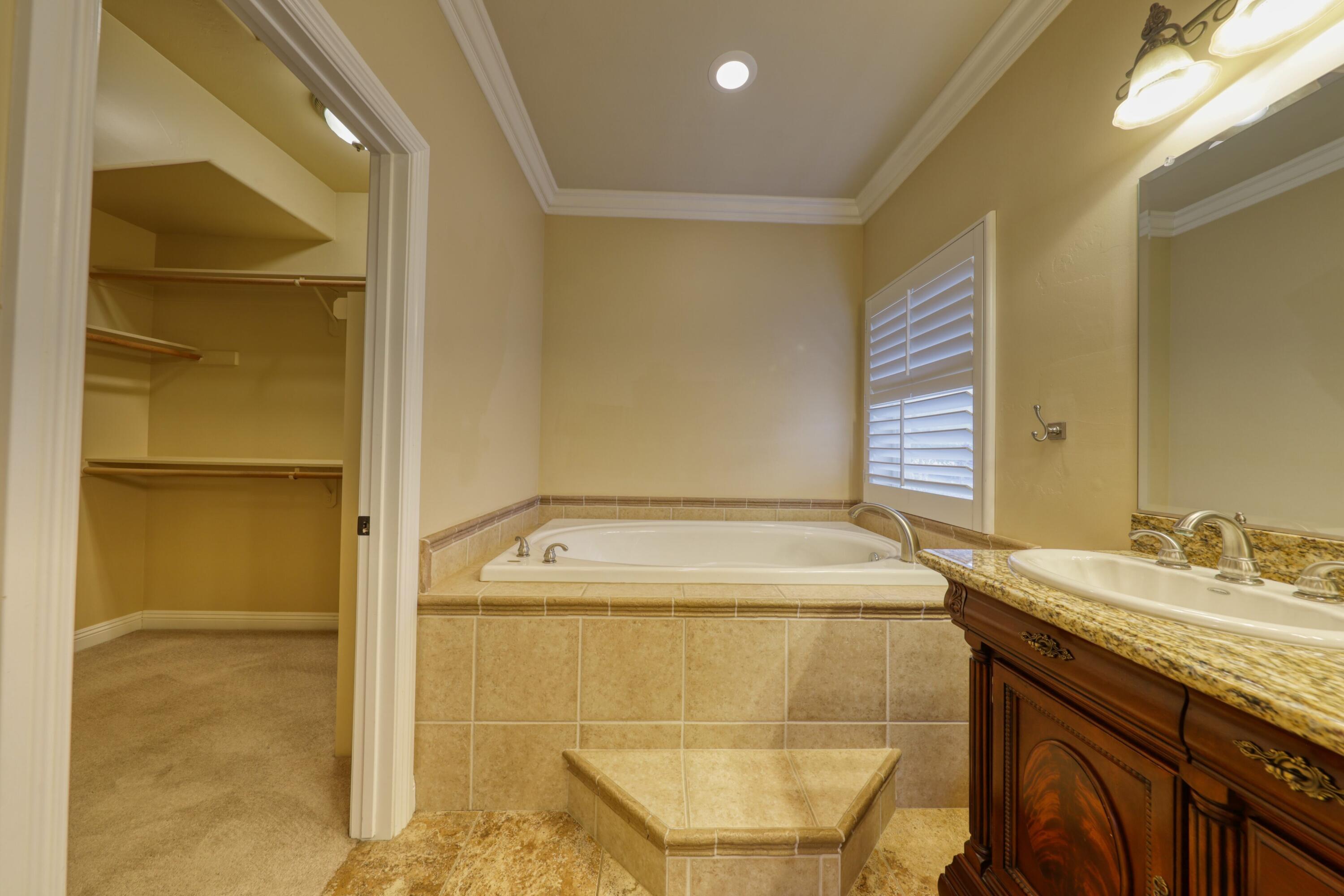 24281 Jacaranda Drive Tehachapi, CA 93561 - Photo 20 of 54 a bathroom with a sink and a mirror