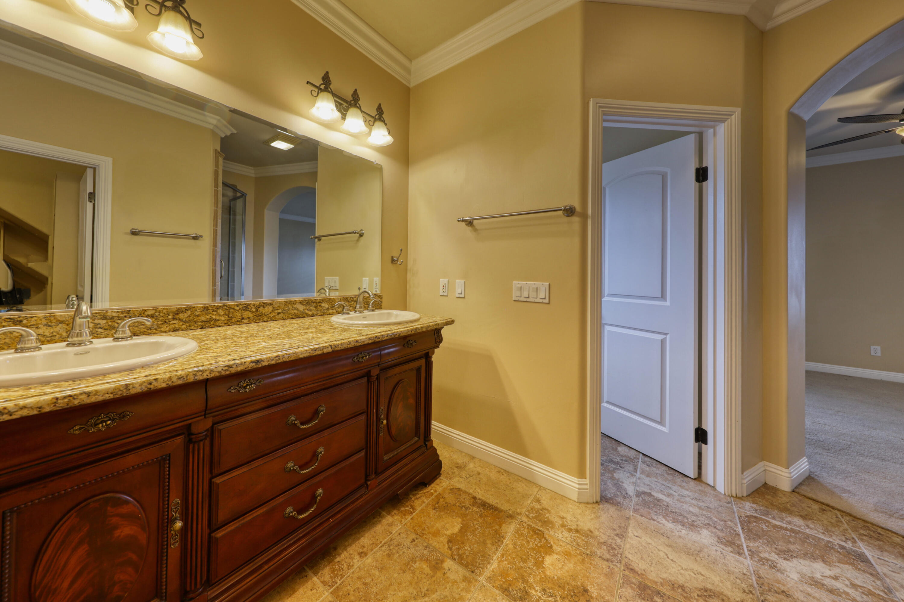 24281 Jacaranda Drive Tehachapi, CA 93561 - Photo 23 of 54 a bathroom with a granite countertop sink and a mirror