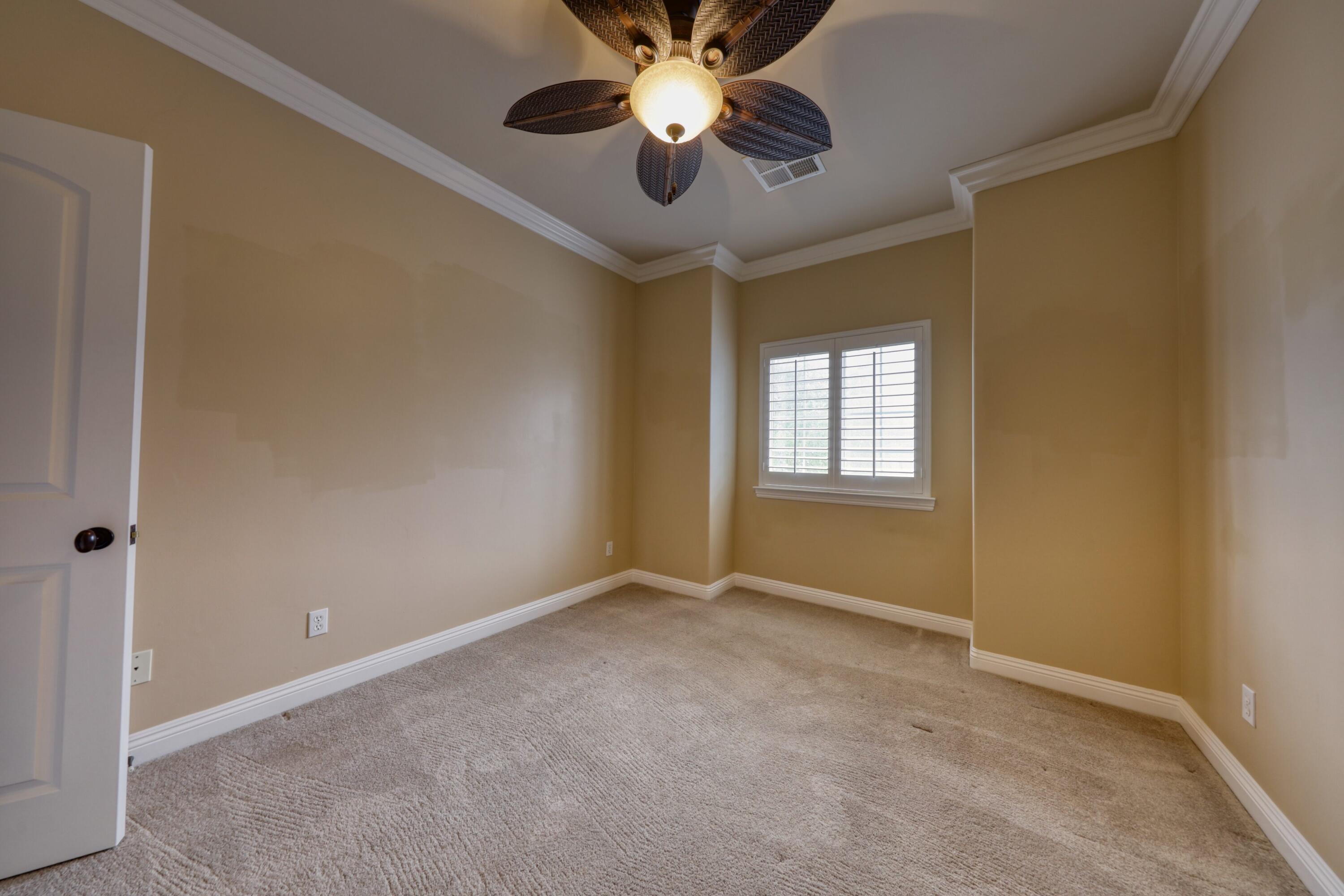 24281 Jacaranda Drive Tehachapi, CA 93561 - Photo 27 of 54 a view of an empty room and a ceiling fan and window