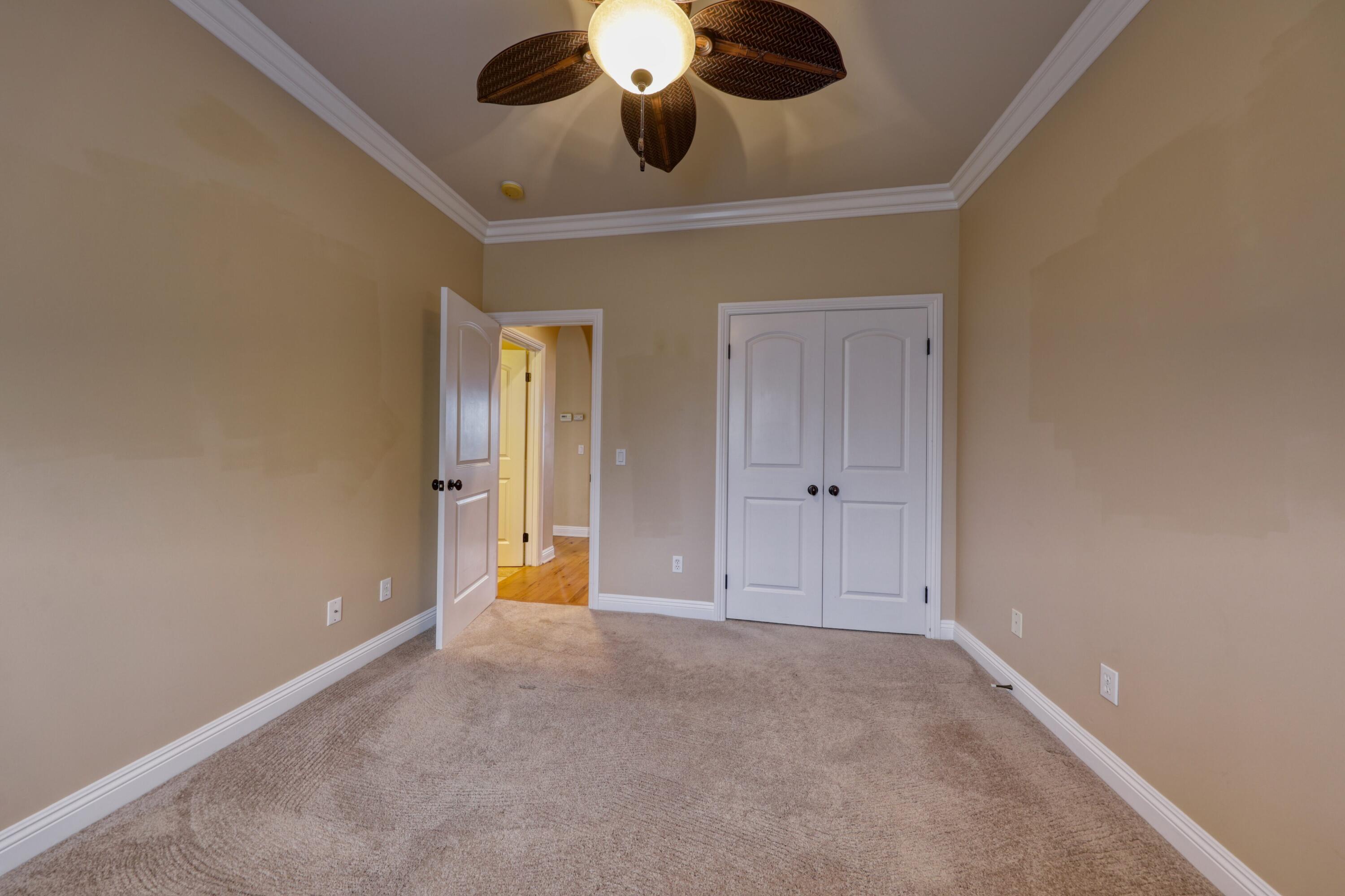 24281 Jacaranda Drive Tehachapi, CA 93561 - Photo 32 of 54 en view of an empty room and chandelier fan