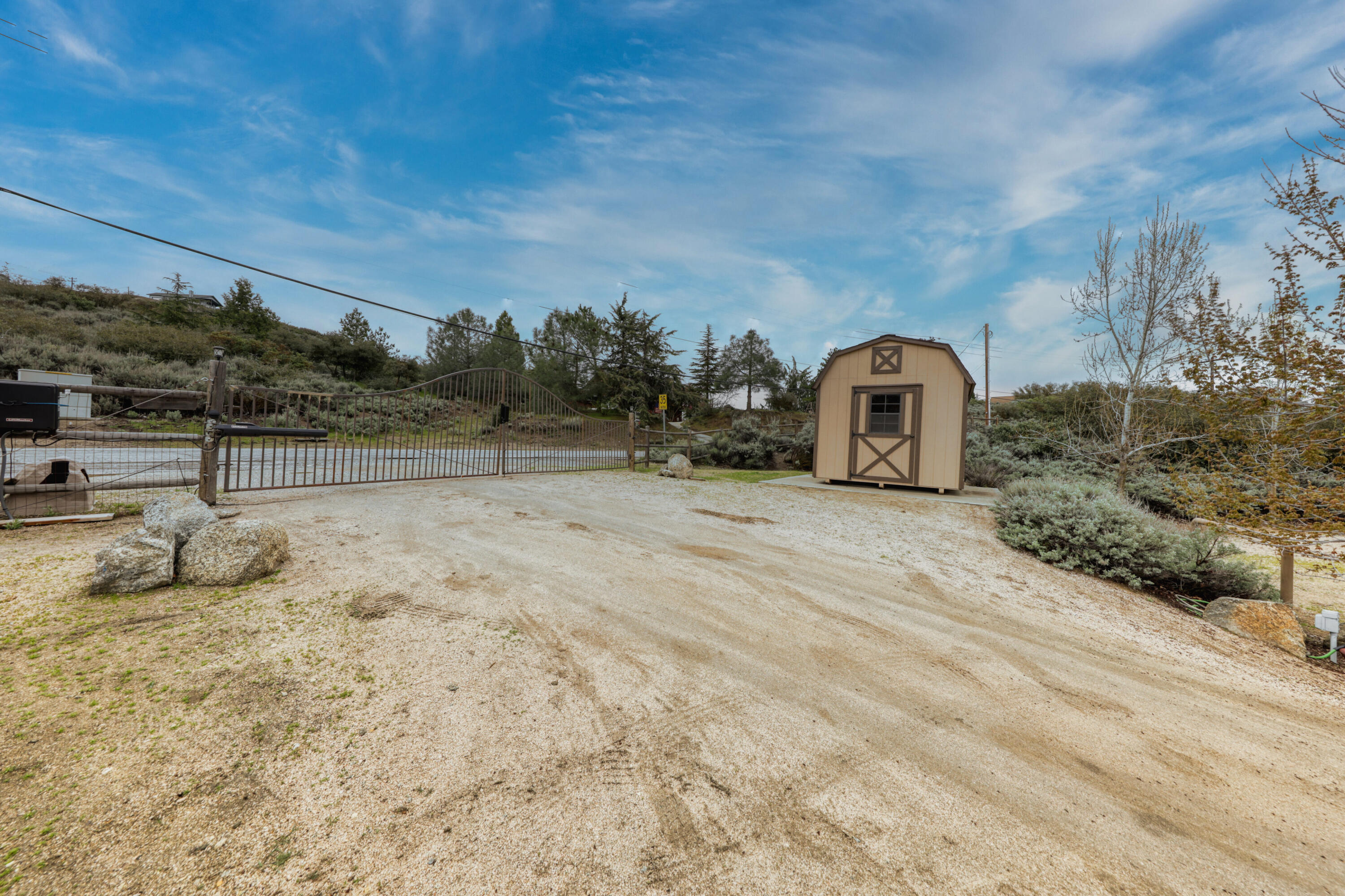 24281 Jacaranda Drive Tehachapi, CA 93561 - Photo 36 of 54 a view of a field with some trees in the background