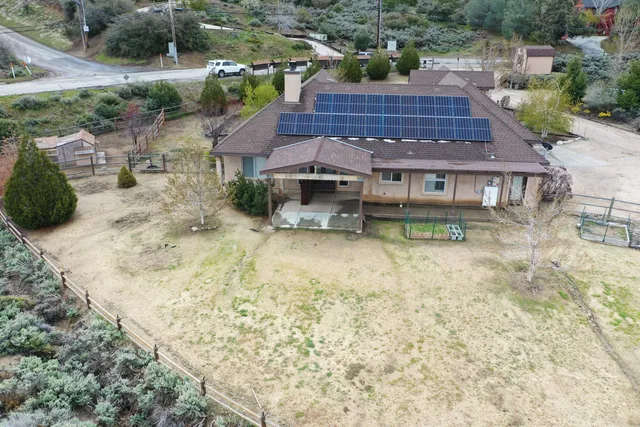an aerial view of a house with a yard basket ball court