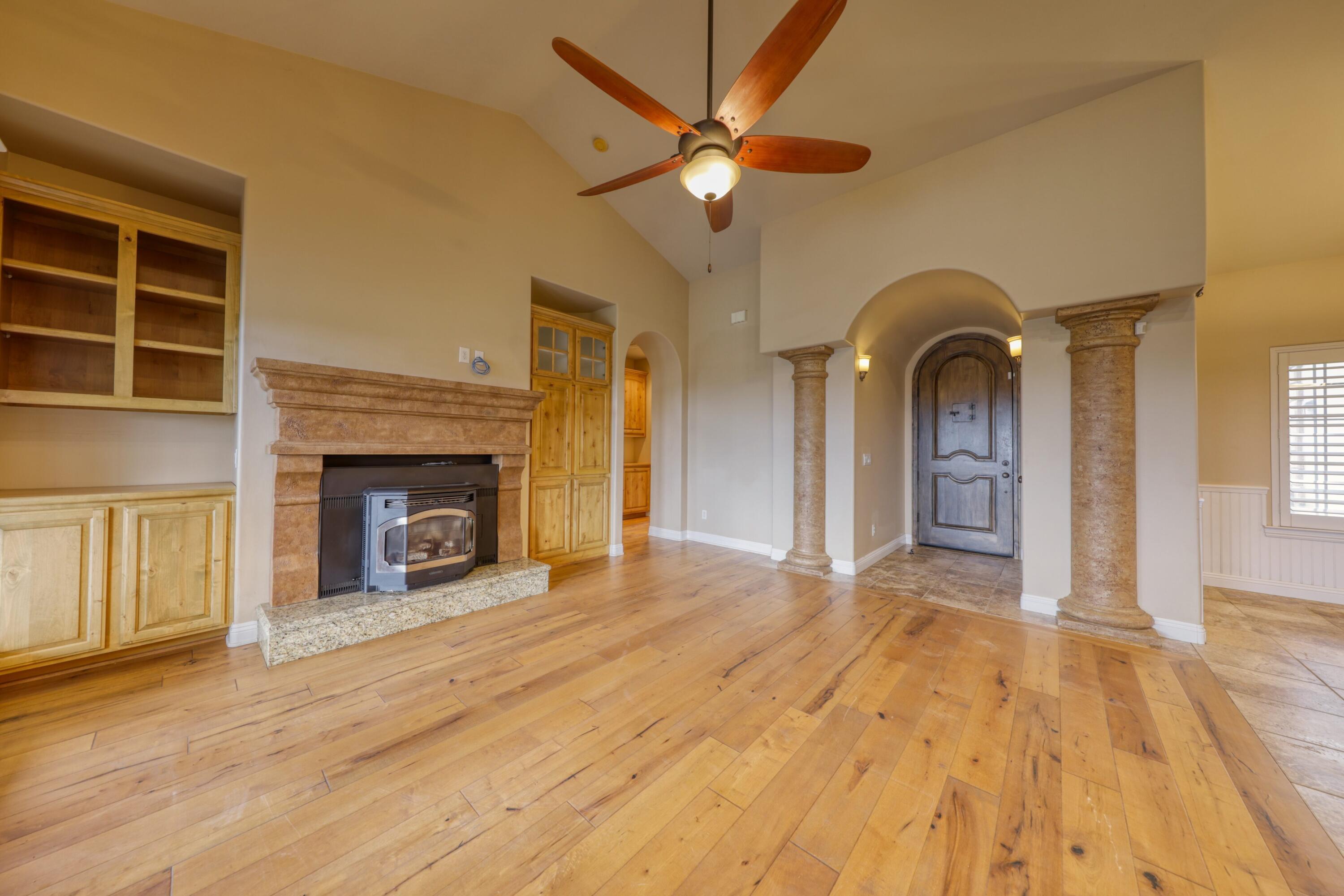 24281 Jacaranda Drive Tehachapi, CA 93561 - Photo 5 of 54 a view of empty room with a fireplace and wooden floor