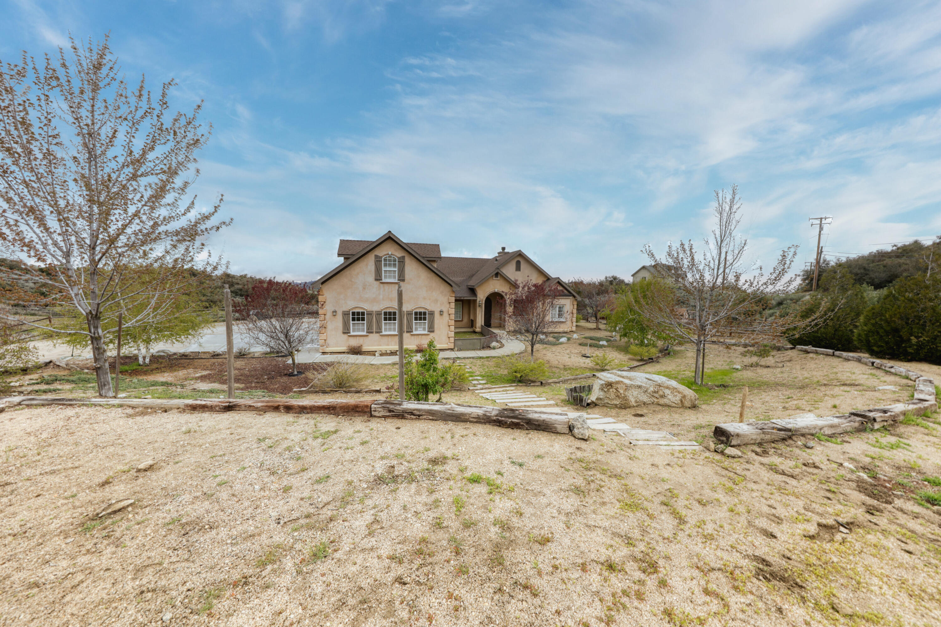 24281 Jacaranda Drive Tehachapi, CA 93561 - Photo 51 of 54 a view of dirt yard with a house