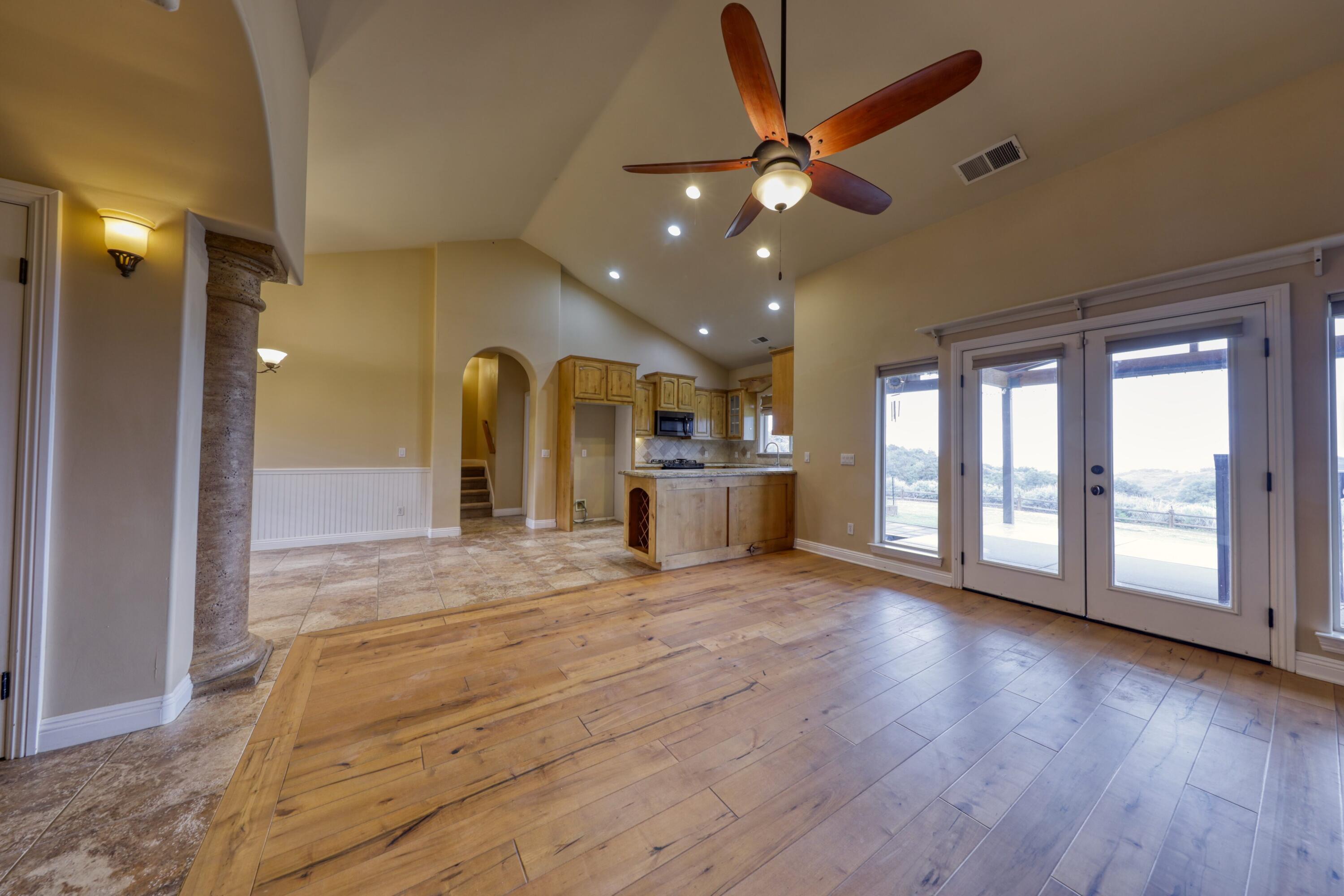 24281 Jacaranda Drive Tehachapi, CA 93561 - Photo 8 of 54 a view of an empty room with window and wooden floor