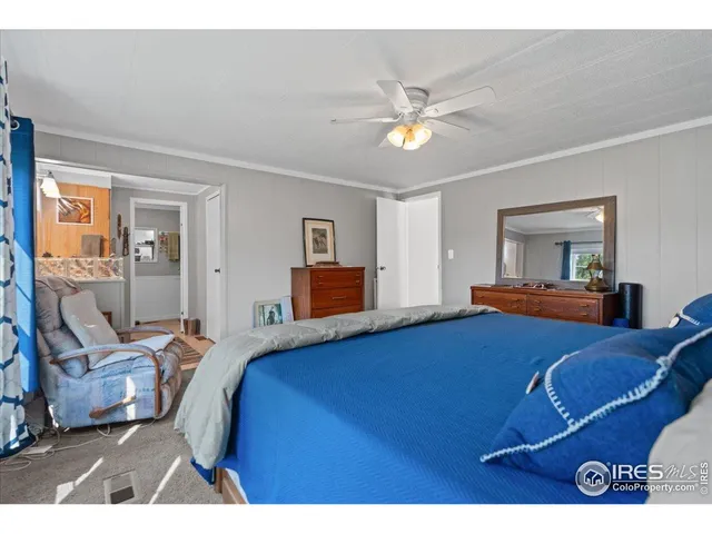 a picture of a kitchen with wooden floor and cabinets