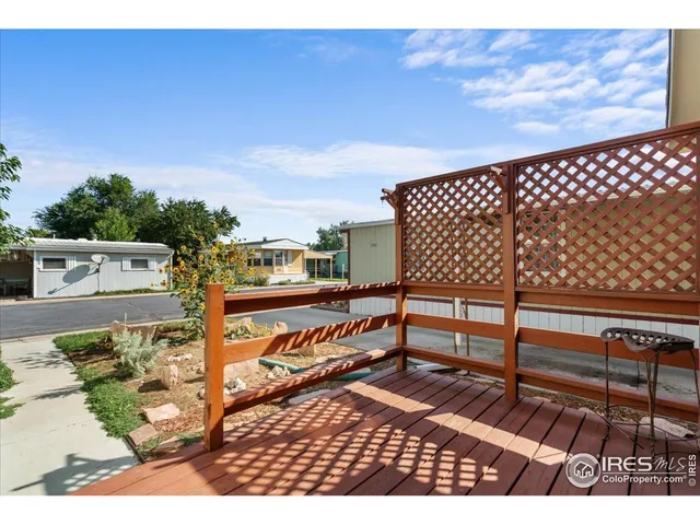 a green field with lots of trees in the background