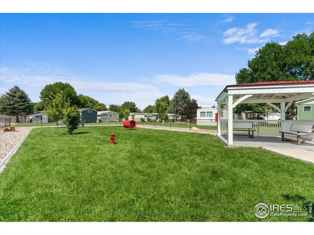 an aerial view of a city with lots of residential buildings and mountain view in back
