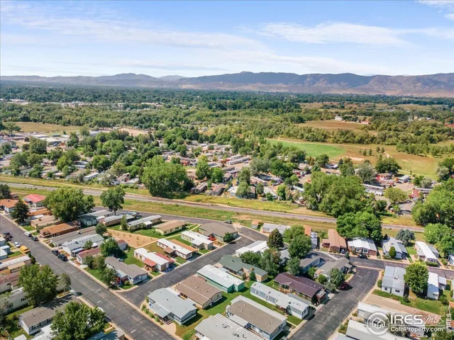 an aerial view of a city with lots of residential buildings and ocean view in back