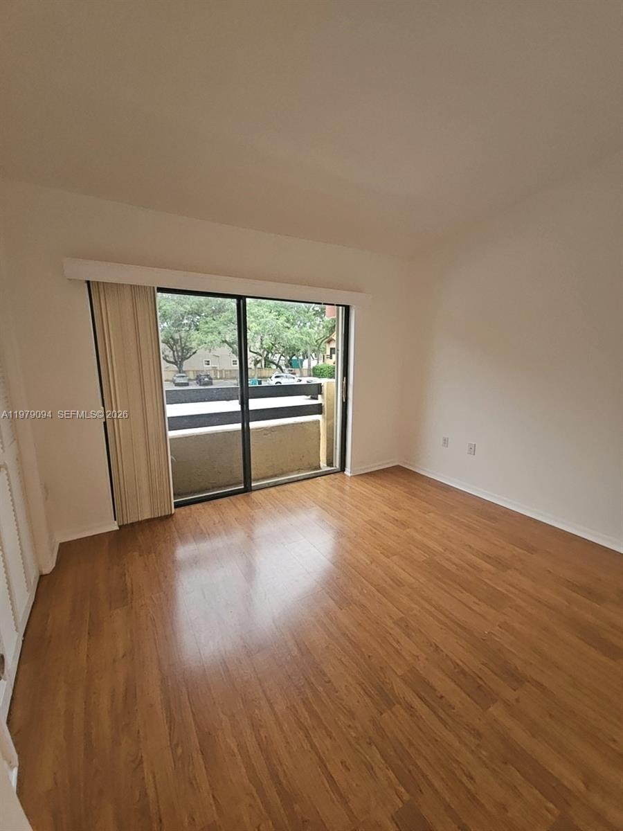 7870 Southwest 102nd Lane Miami, FL 33156 - Photo 19 of 41 an empty room with wooden floor and windows
