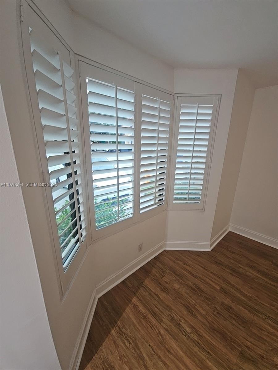 7870 Southwest 102nd Lane Miami, FL 33156 - Photo 36 of 41 a view of an empty room with a window and wooden floor