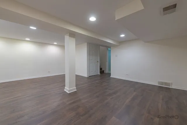 an empty room with wooden floor