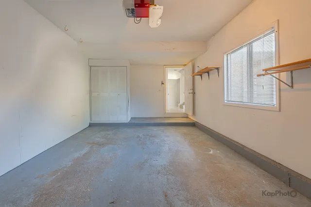 an empty room with a chandeliers fan