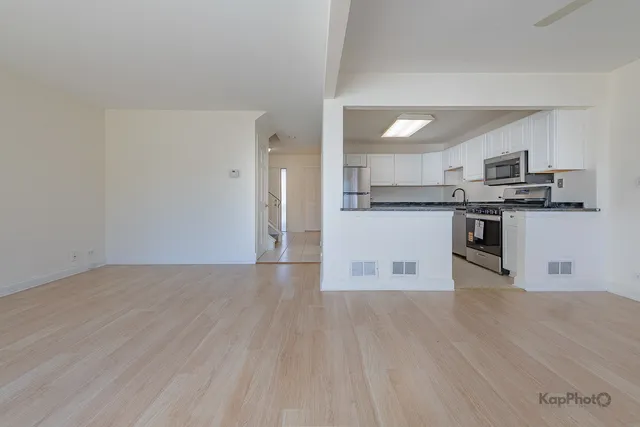 a kitchen with stainless steel appliances granite countertop a stove top oven and sink