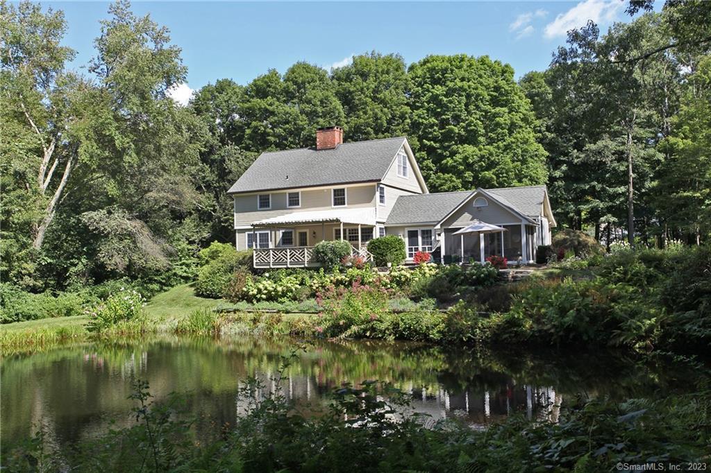 a front view of a house with a yard and lake view