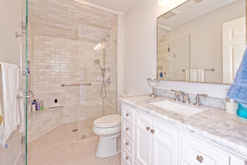 16 Bridle Path Shrewsbury, MA 01545 - Photo 16 of 42 a bathroom with a granite countertop sink a toilet and shower