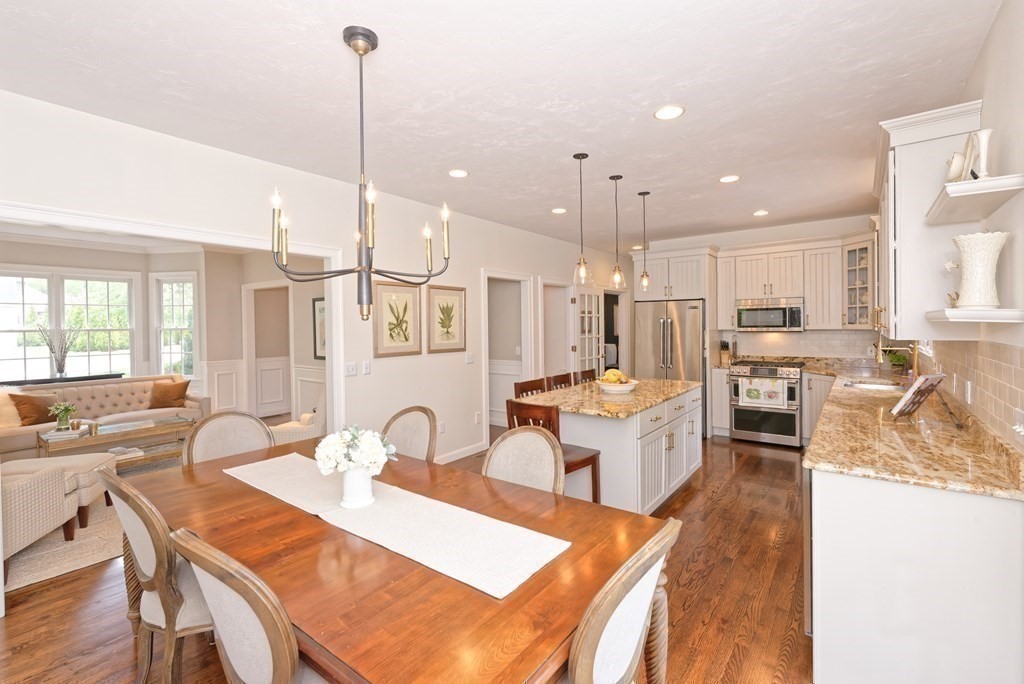 16 Bridle Path Shrewsbury, MA 01545 - Photo 3 of 42 a open kitchen with stainless steel appliances kitchen island granite countertop a dining table chairs and white cabinets
