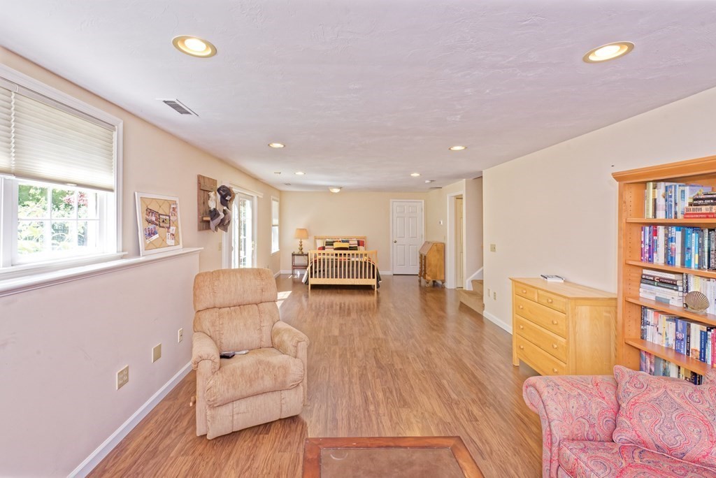 16 Bridle Path Shrewsbury, MA 01545 - Photo 32 of 42 a living room with furniture and a book shelf