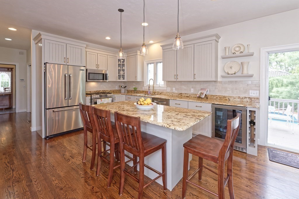 16 Bridle Path Shrewsbury, MA 01545 - Photo 4 of 42 a kitchen with stainless steel appliances granite countertop a dining table chairs refrigerator sink and cabinets