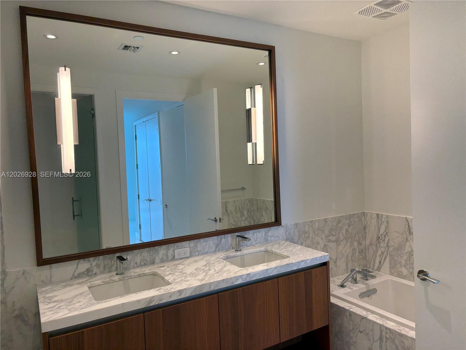 175 Southeast 25th Road, Unit 901 Miami, FL 33129 - Photo 10 of 18 a bathroom with a sink and a mirror