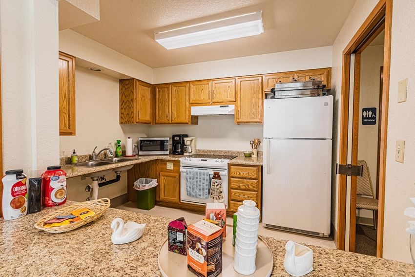 556 G Street Jacksonville, OR 97530 - Photo 11 of 12 a kitchen with stainless steel appliances granite countertop a refrigerator sink stove and wooden floor