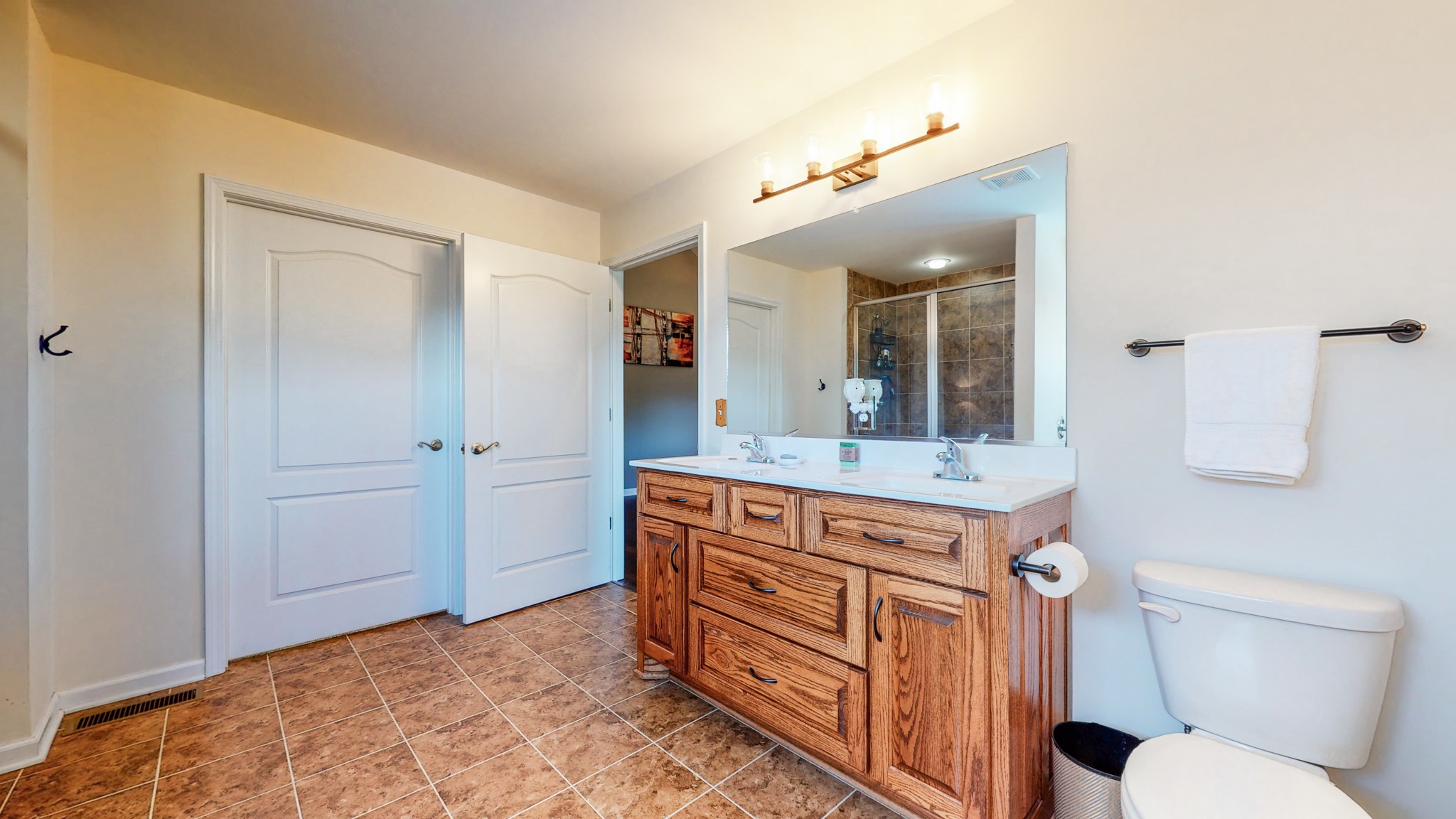 1439 Cliff Amos Road Spring Hill, TN 37174 - Photo 20 of 64 a bathroom with a granite countertop toilet a sink and a mirror