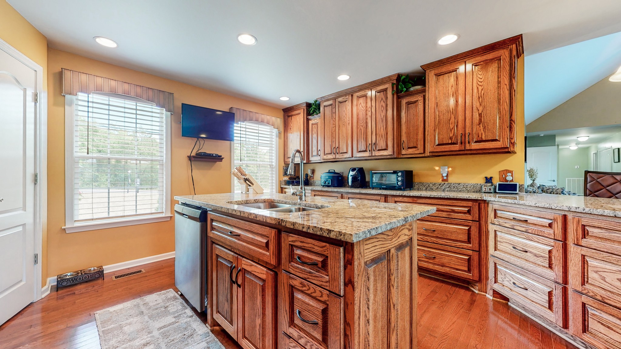 1439 Cliff Amos Road Spring Hill, TN 37174 - Photo 3 of 64 a kitchen with stainless steel appliances granite countertop a stove a sink and dishwasher wooden cabinets with wooden floor
