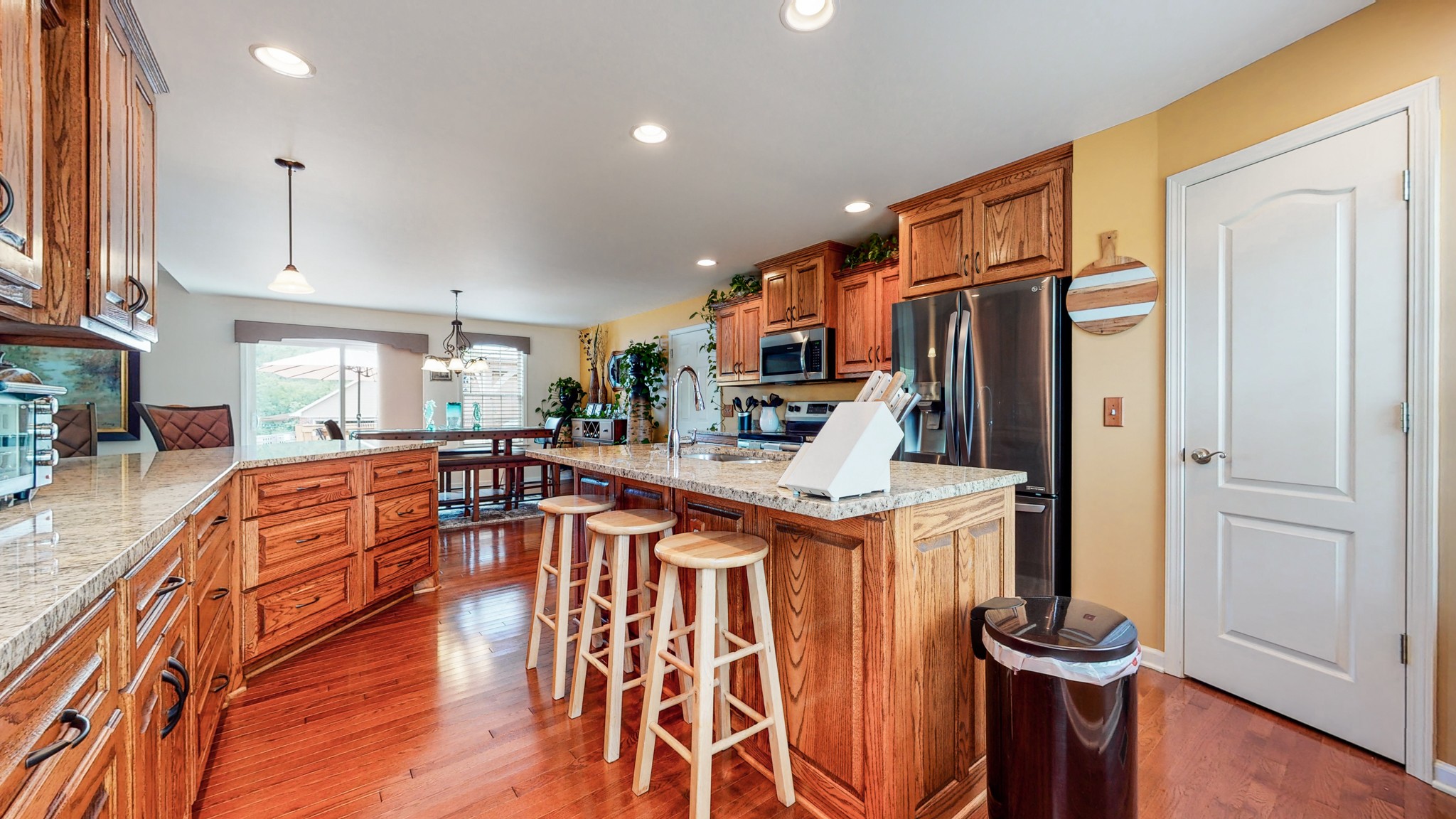 1439 Cliff Amos Road Spring Hill, TN 37174 - Photo 6 of 64 a kitchen with stainless steel appliances granite countertop a refrigerator a stove and a wooden floors