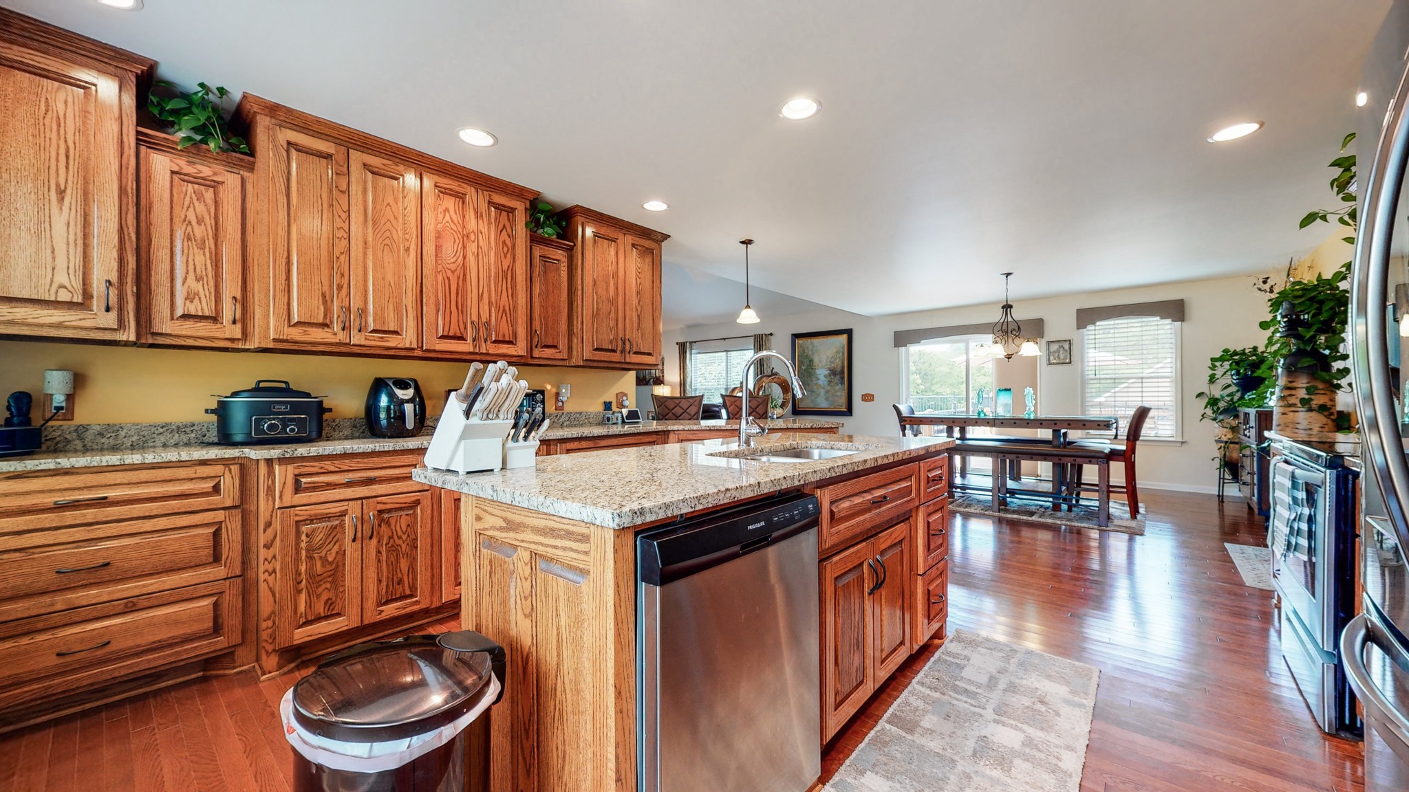 1439 Cliff Amos Road Spring Hill, TN 37174 - Photo 7 of 64 a kitchen with stainless steel appliances granite countertop a stove a sink dishwasher and cabinets with wooden floor