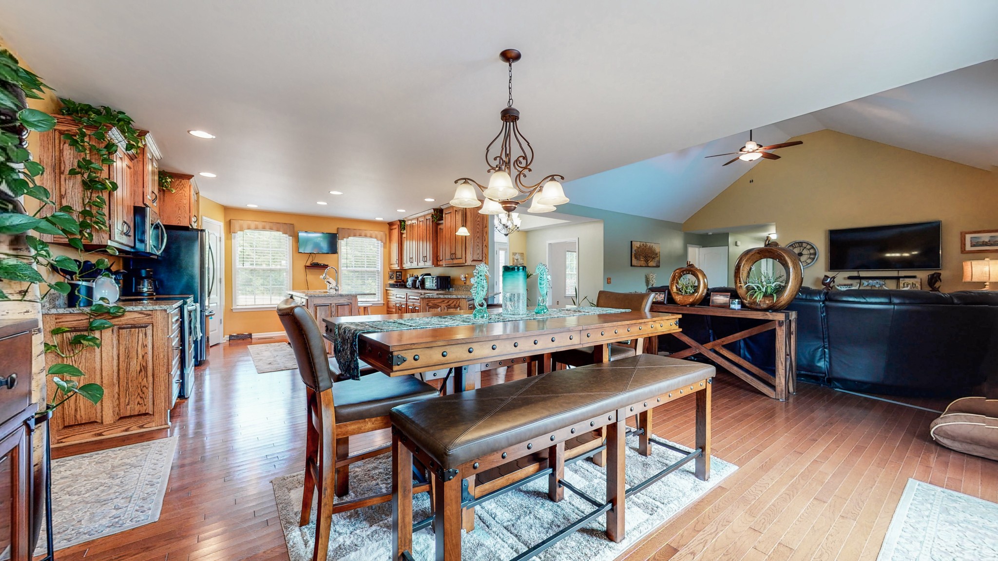 1439 Cliff Amos Road Spring Hill, TN 37174 - Photo 10 of 64 a dining room with wooden floor a chandelier a wooden table and chairs