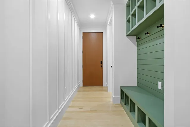 a view of entryway and hall with wooden floor