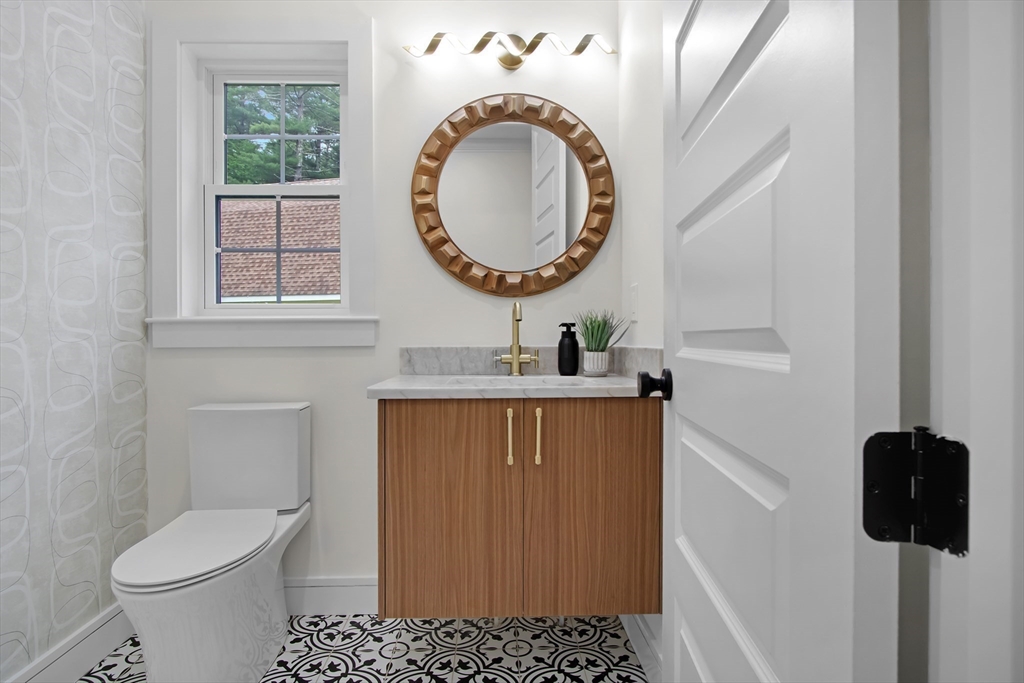 293 Cross Street Norwell, MA 02061 - Photo 13 of 38 a bathroom with a sink a toilet and a mirror