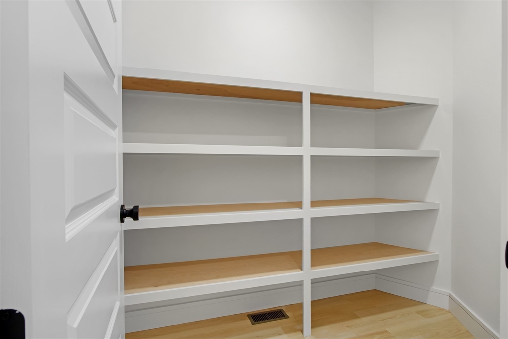 293 Cross Street Norwell, MA 02061 - Photo 14 of 38 a view of walk in closet with empty racks