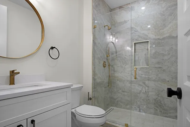 a bathroom with a sink a window and shower