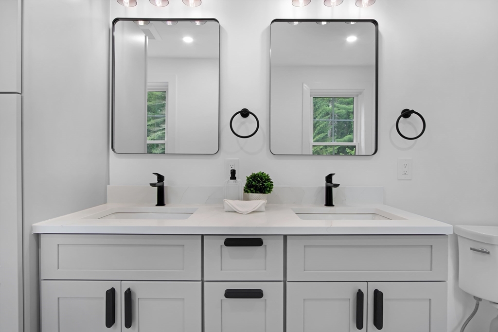 293 Cross Street Norwell, MA 02061 - Photo 26 of 38 a bathroom with a sink and a mirror