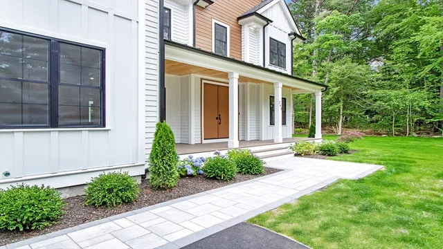 a living room with furniture a chandelier and a window