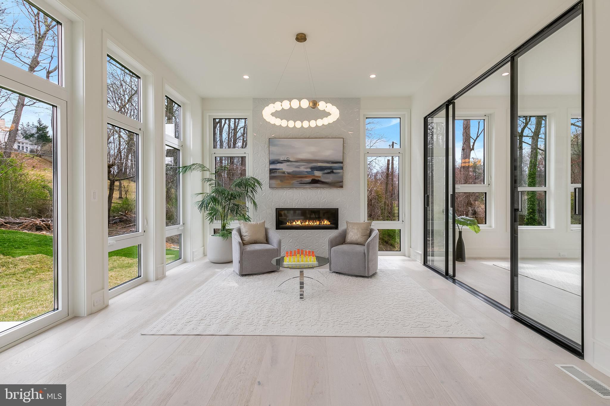 8757 Brook Road McLean, VA 22102 - Photo 13 of 45 a living room with furniture a fireplace and a large window