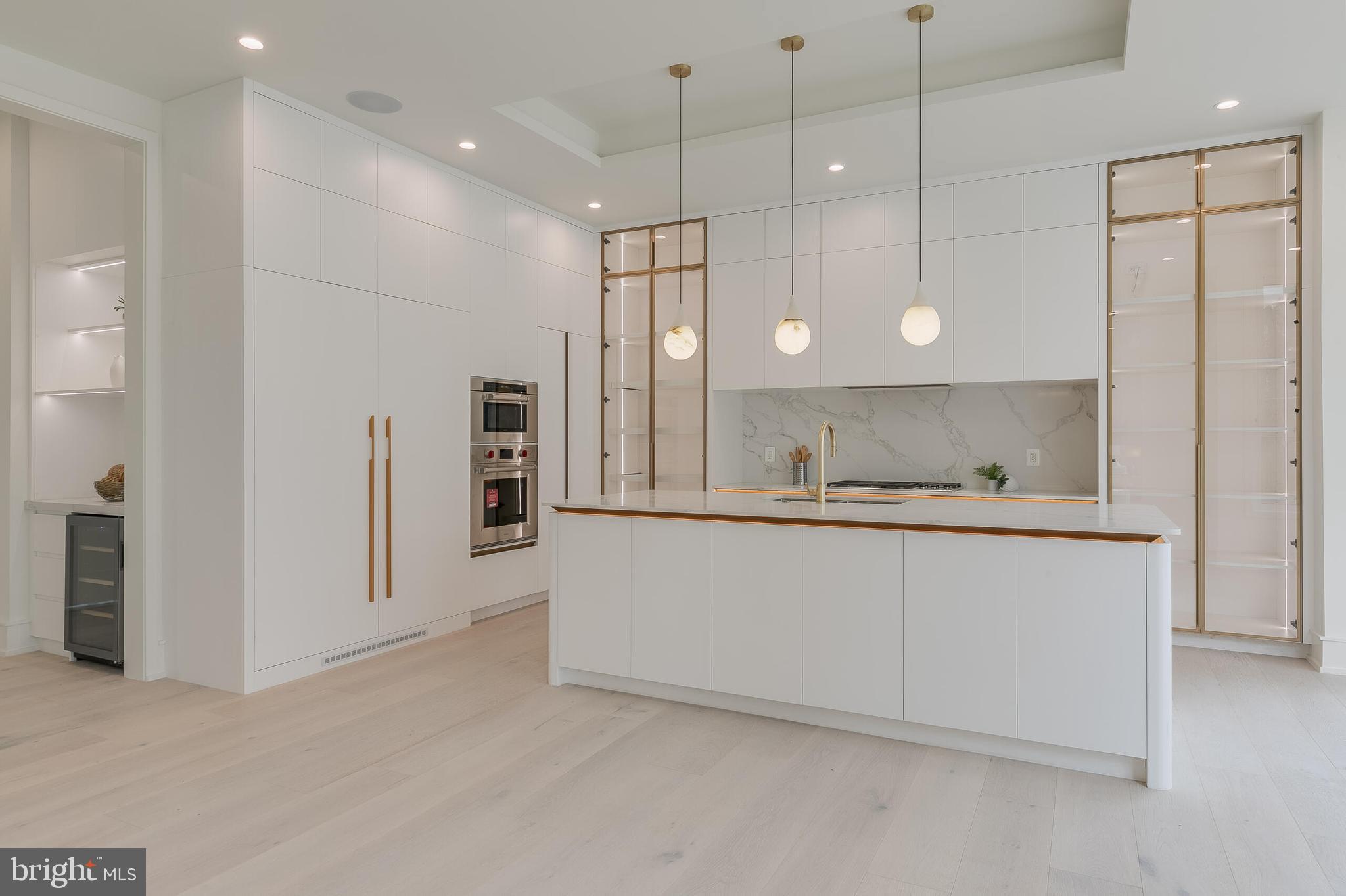 8757 Brook Road McLean, VA 22102 - Photo 15 of 45 a large white kitchen with a refrigerator a sink and a oven
