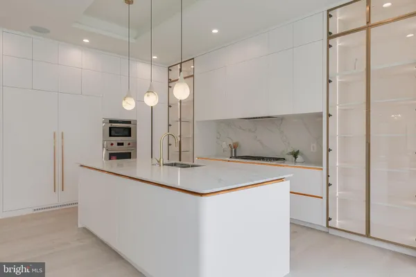a kitchen with a sink a counter space and stainless steel appliances