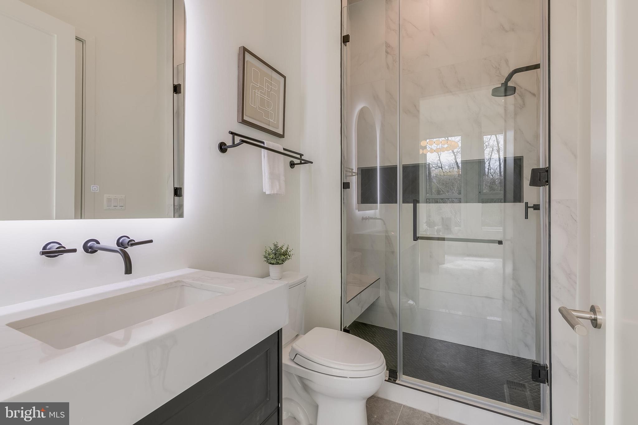 8757 Brook Road McLean, VA 22102 - Photo 30 of 45 a bathroom with a sink toilet and shower