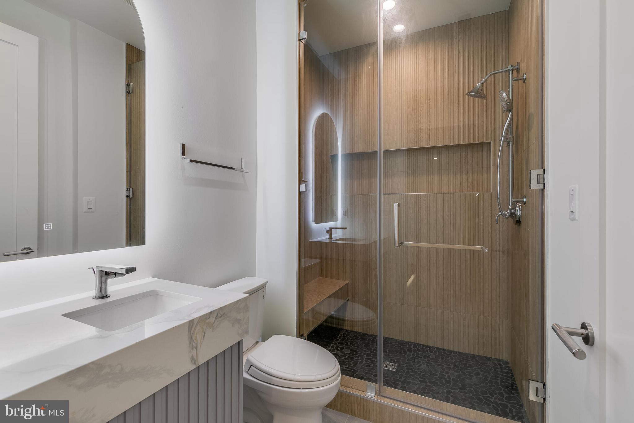 8757 Brook Road McLean, VA 22102 - Photo 40 of 45 a bathroom with a sink toilet and shower