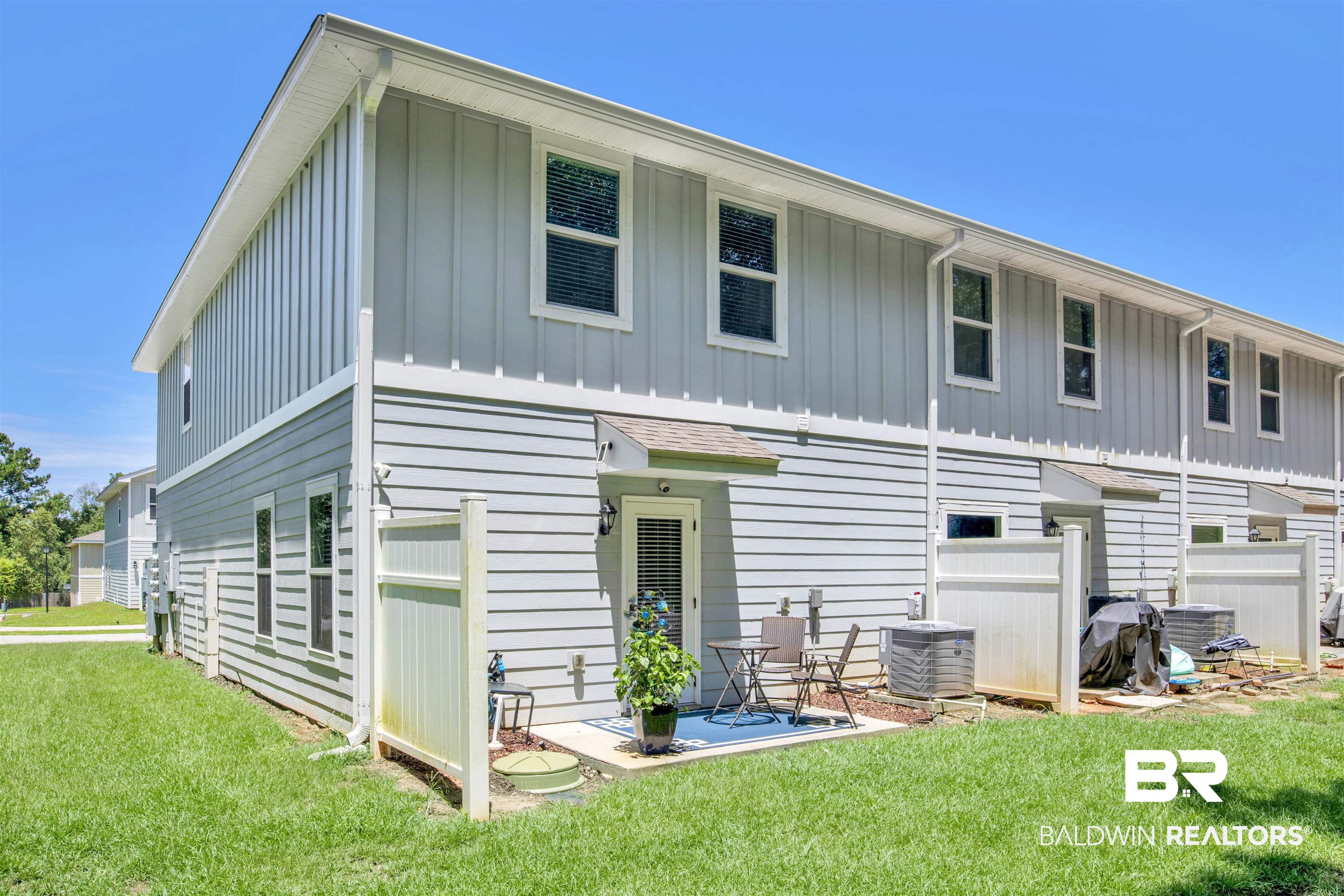 25806 Pollard Road, Unit 20 Daphne, AL 36526 - Photo 26 of 29 Back of house featuring cooling unit and a lawn