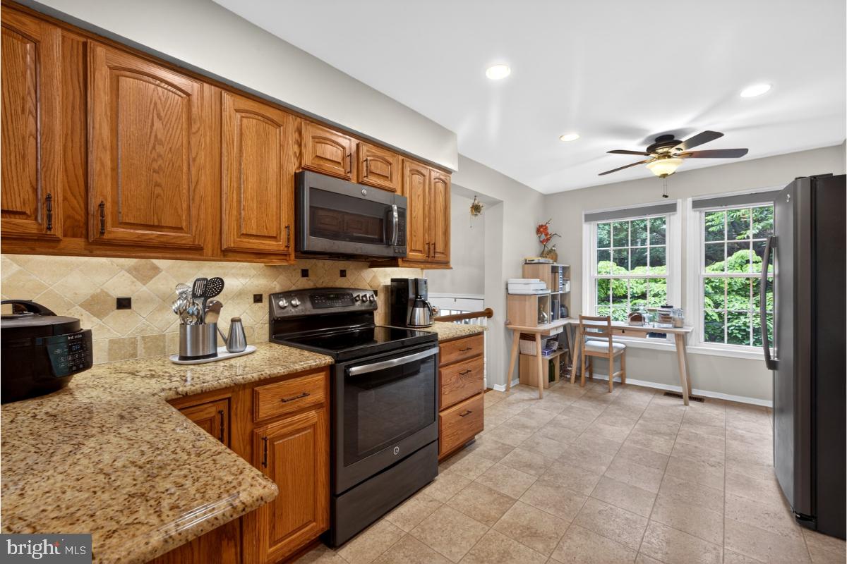 7347 Swan Point Way, Unit 122 Columbia, MD 21045 - Photo 4 of 54 a kitchen with a stove a sink and a microwave