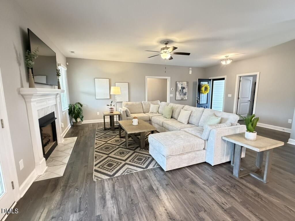 88 Heath Road Lillington, NC 27546 - Photo 3 of 54 a living room with furniture a fireplace and a flat screen tv