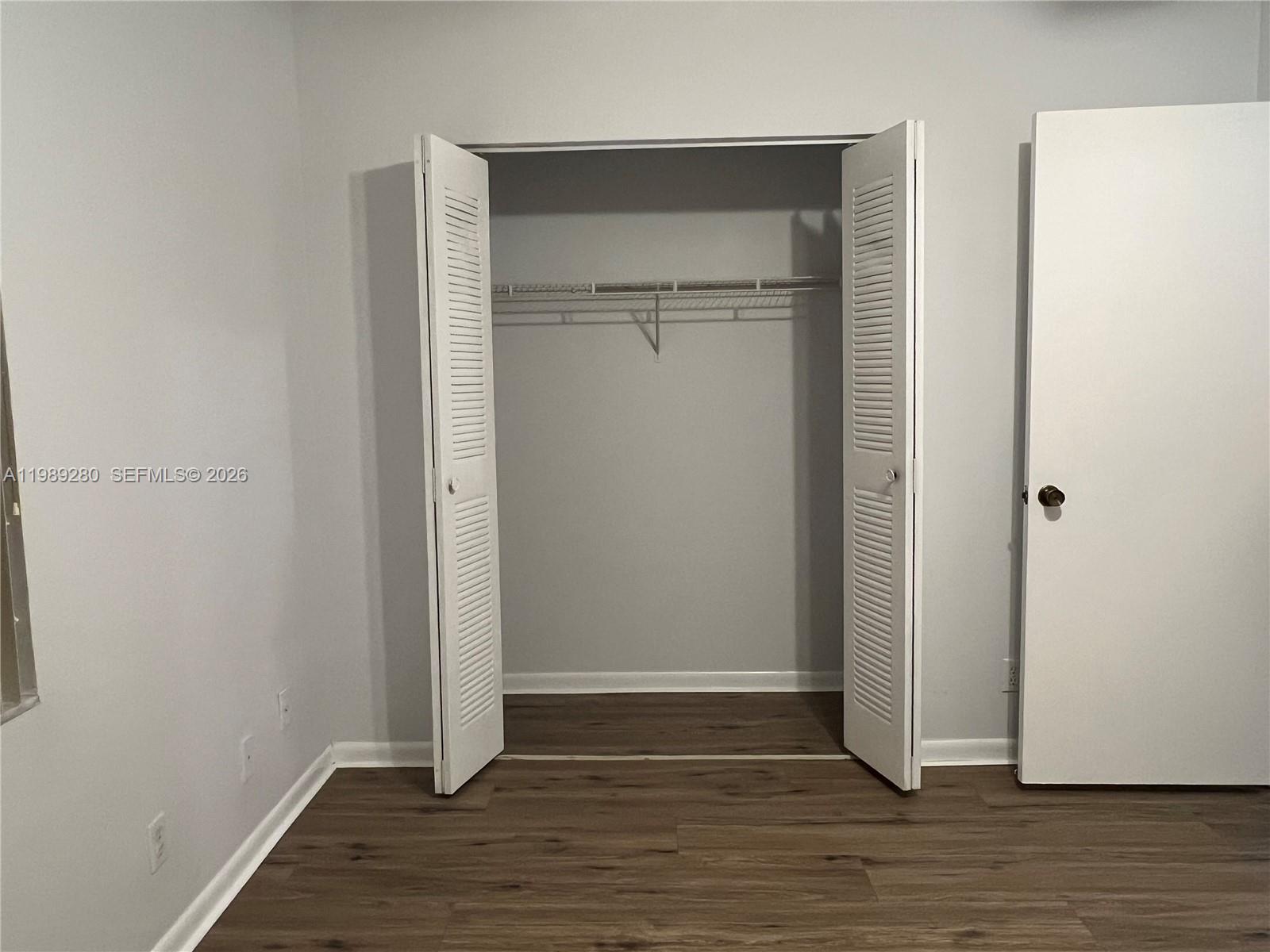 543 Racquet Club Road, Unit 33 Weston, FL 33326 - Photo 26 of 28 a view of an empty room with wooden floor